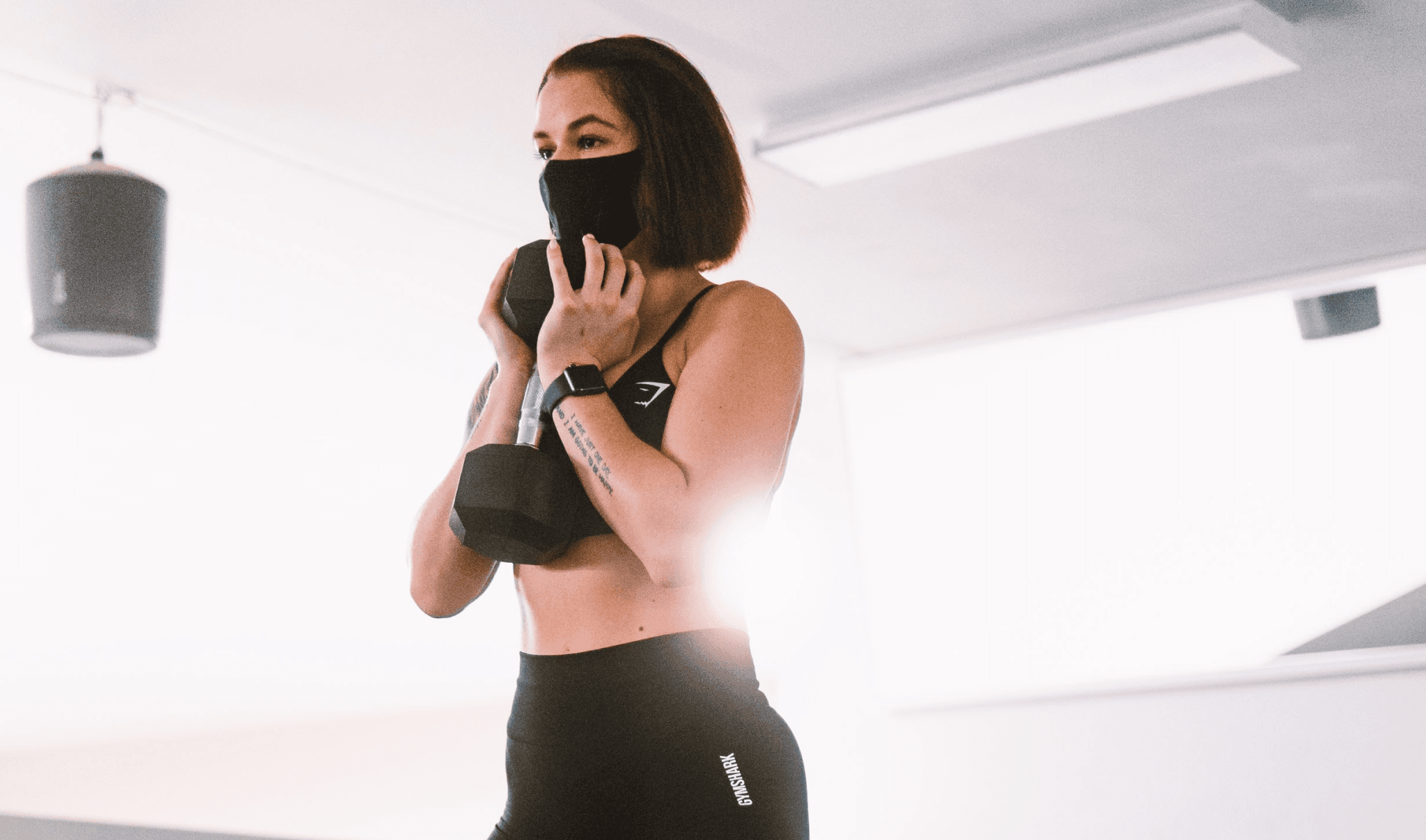 A girl is exercising with weights